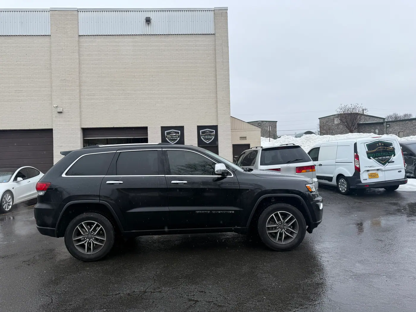 Black SUV with tinted windows, photographed side-on.