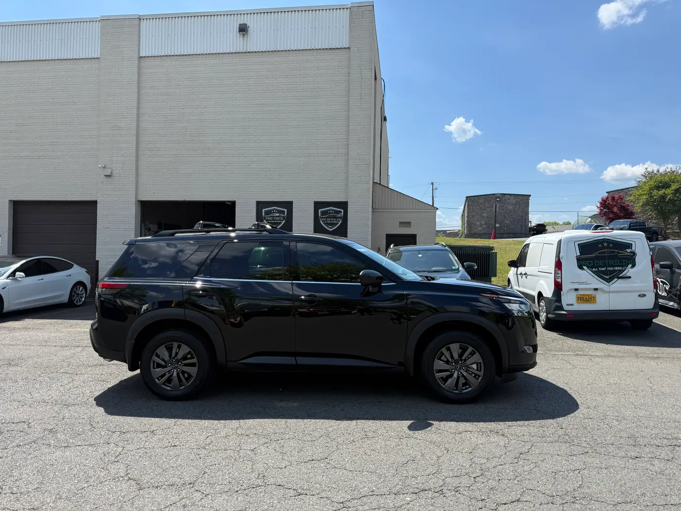 Black SUV with tinted windows, photographed side-on.