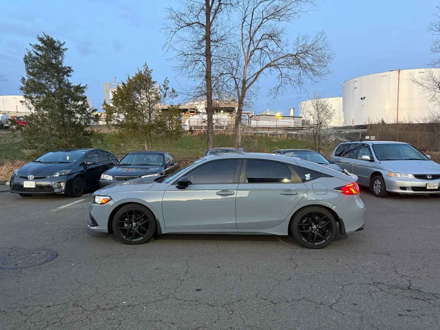 Grey sedan with tinted windows, photographed side-on.