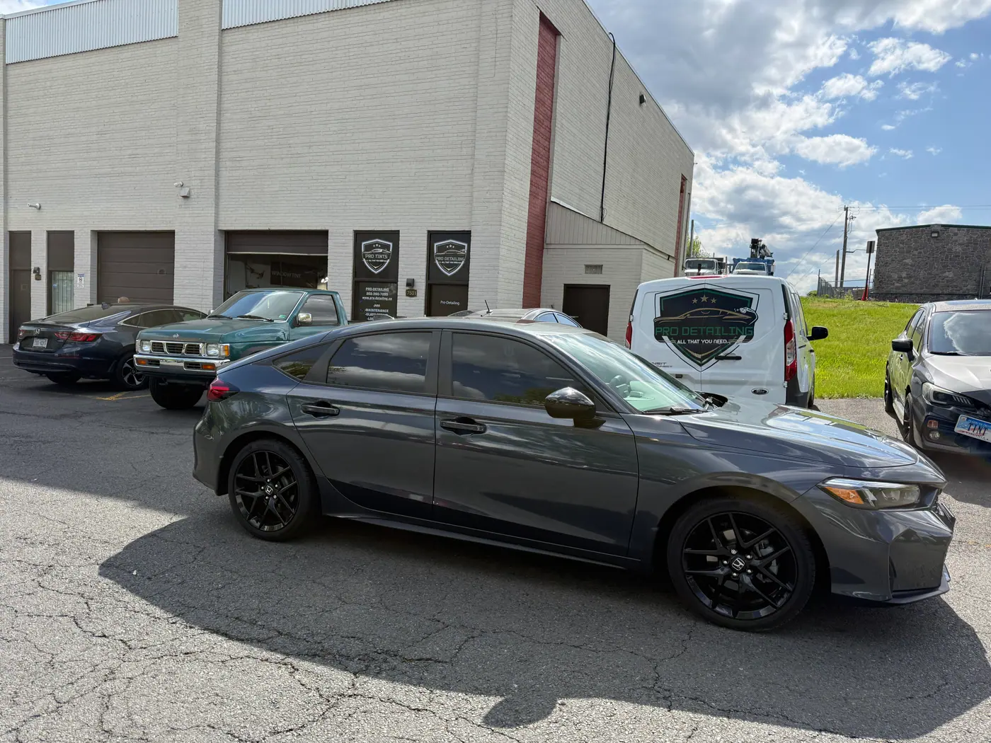 Grey sedan with tinted windows, photographed side-on.