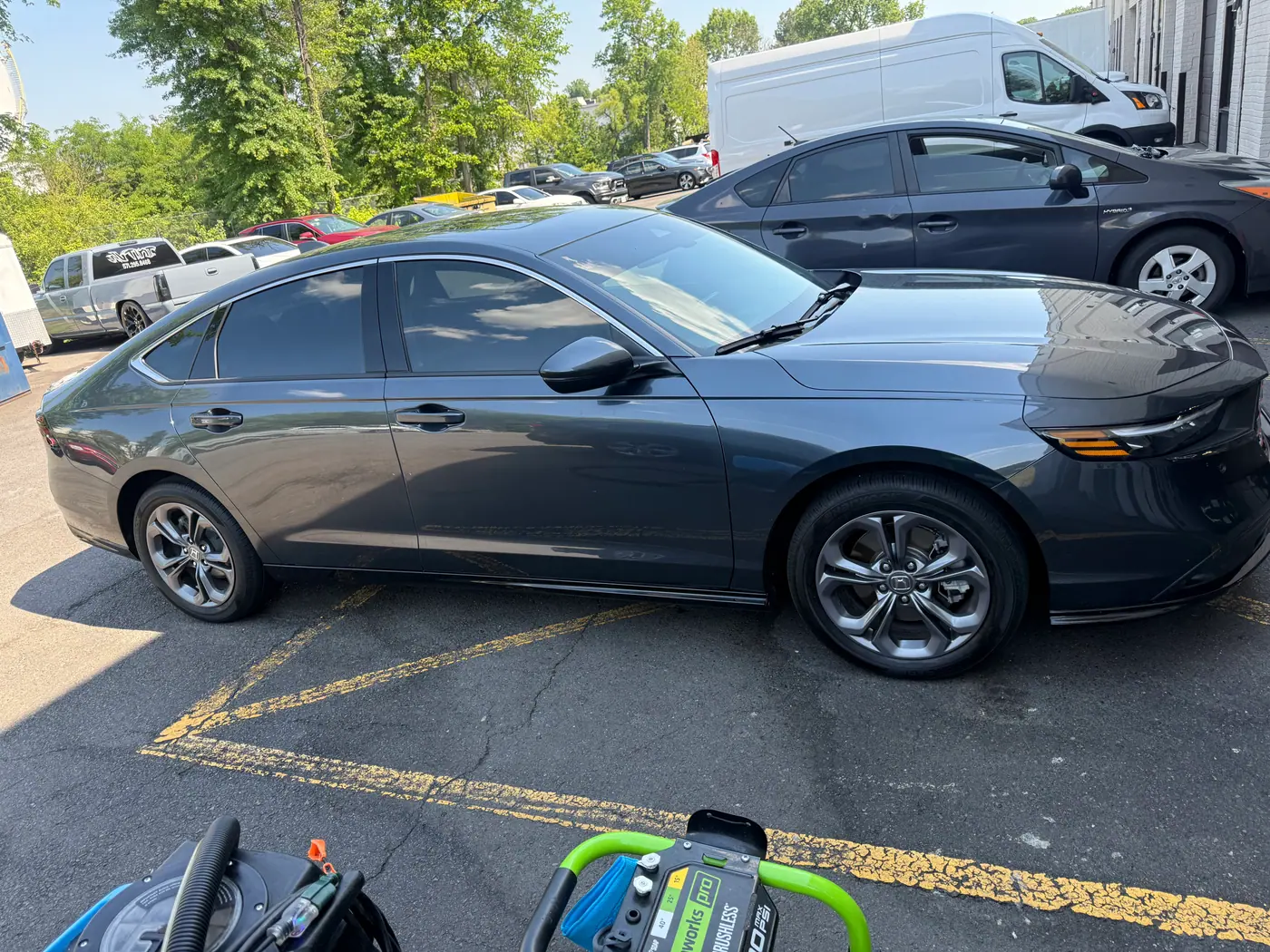Grey sedan with tinted windows, photographed side-on.