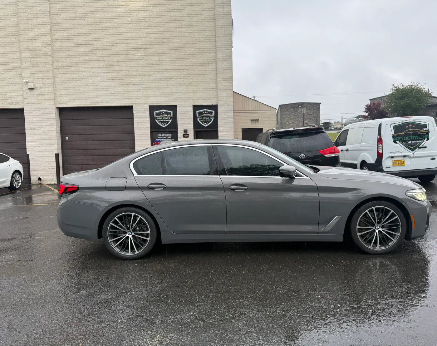 Grey sedan with tinted windows, photographed side-on.