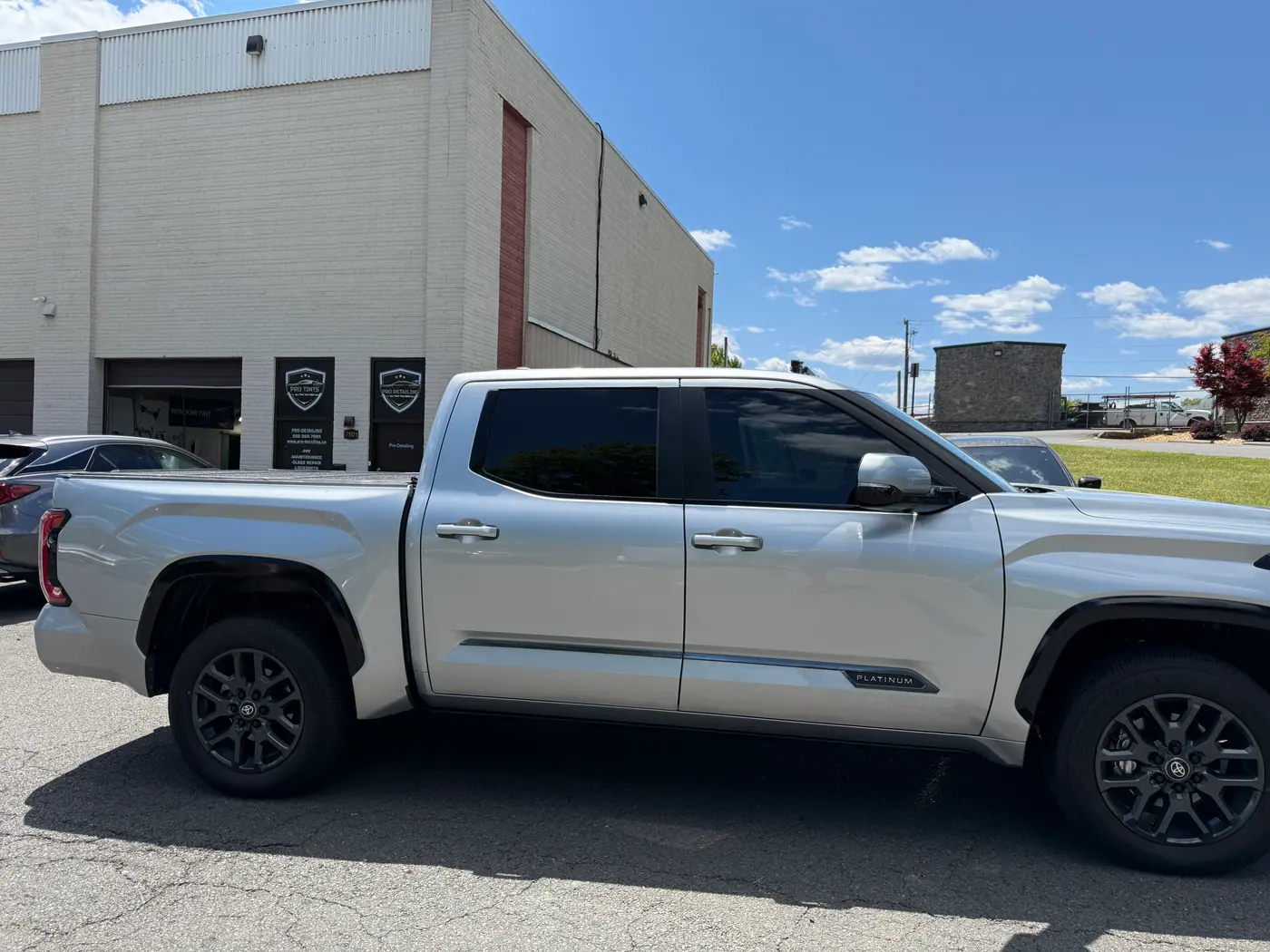 Silver pickup truck with tinted windows, photographed side-on.