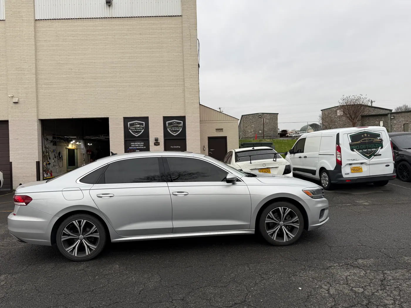 Silver sedan with tinted windows, photographed side-on.