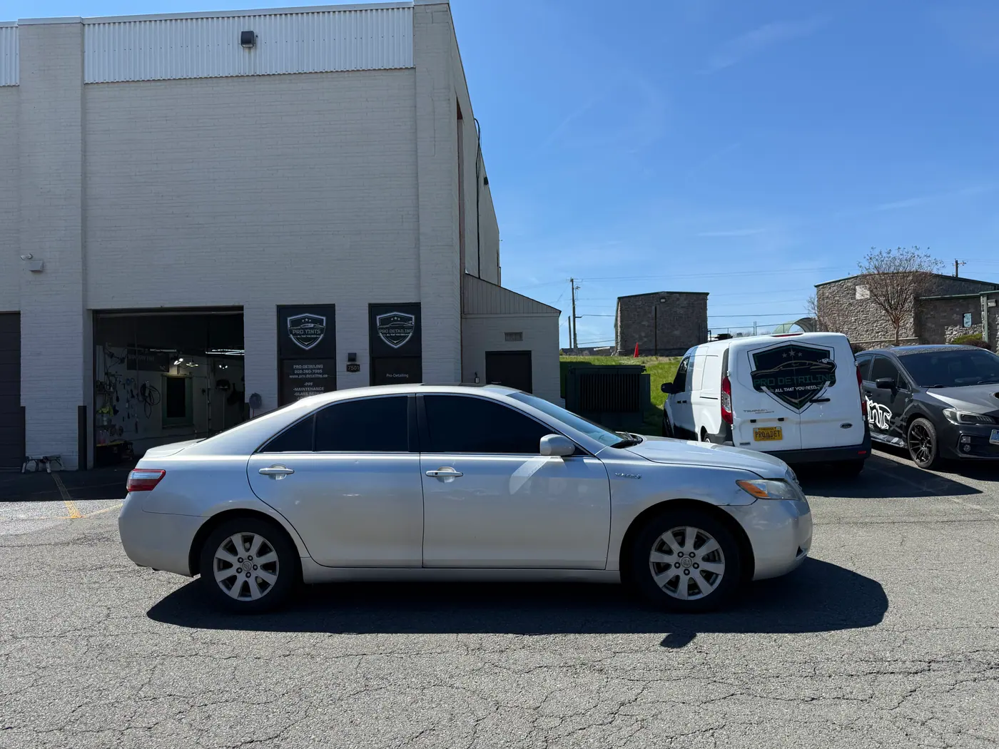 Silver sedan with tinted windows, photographed side-on.