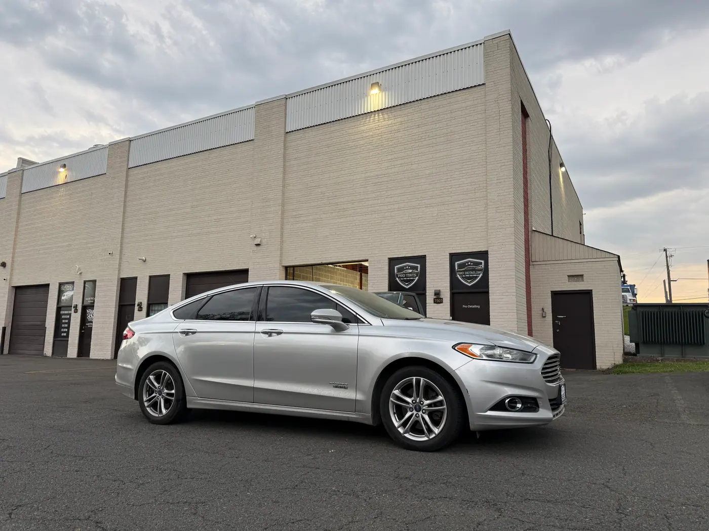 Silver sedan with tinted windows, photographed side-on.