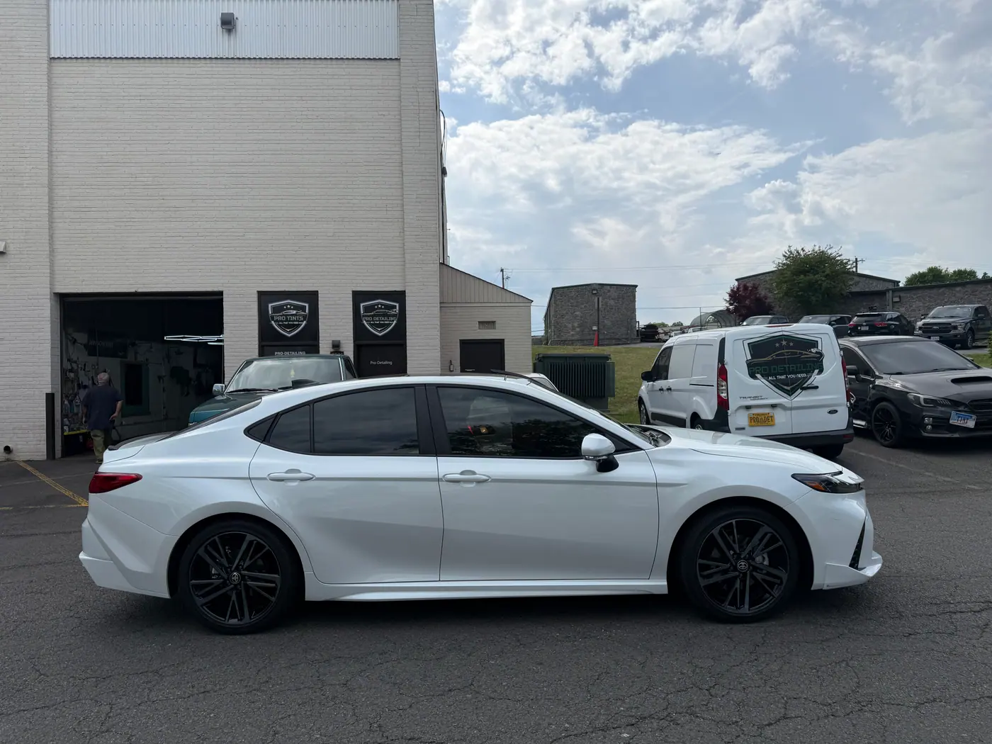 White sedan with tinted windows, photographed side-on.