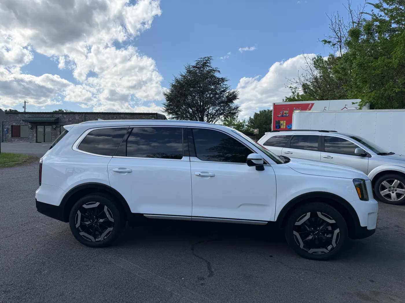White SUV with tinted windows, photographed side-on.