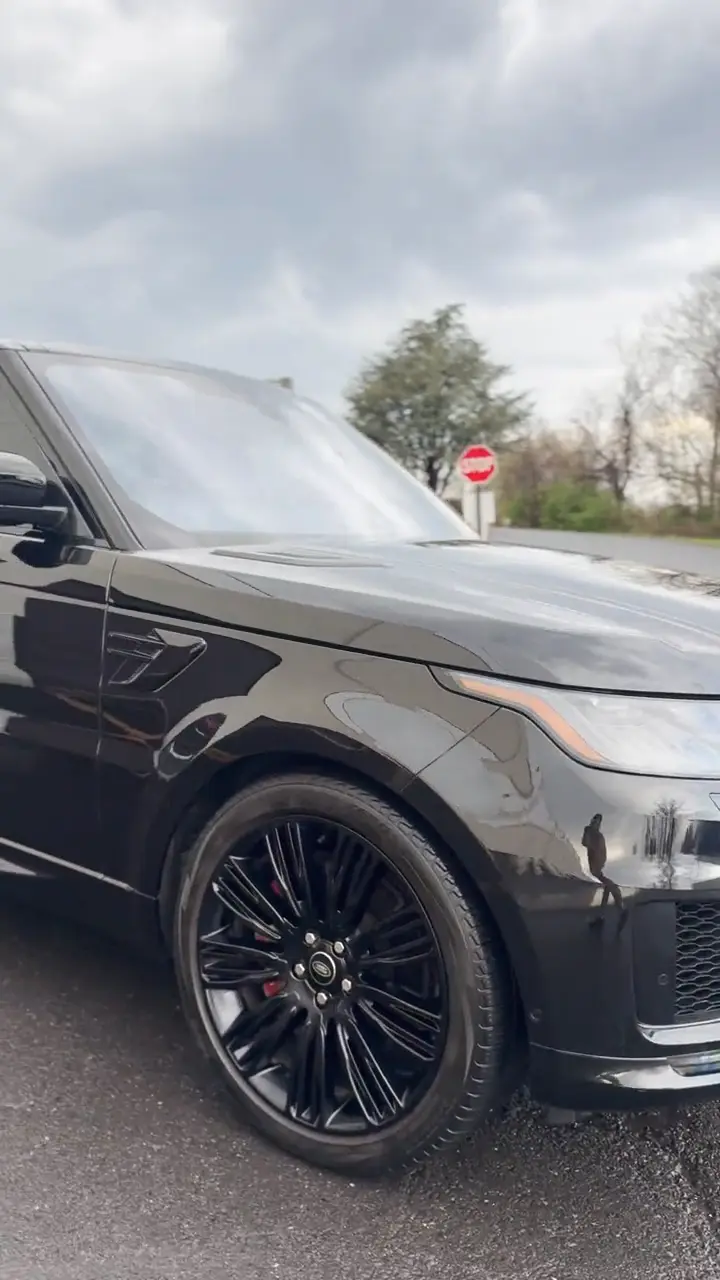 Black SUV with tinted windows, filmed in a slow walk-around.