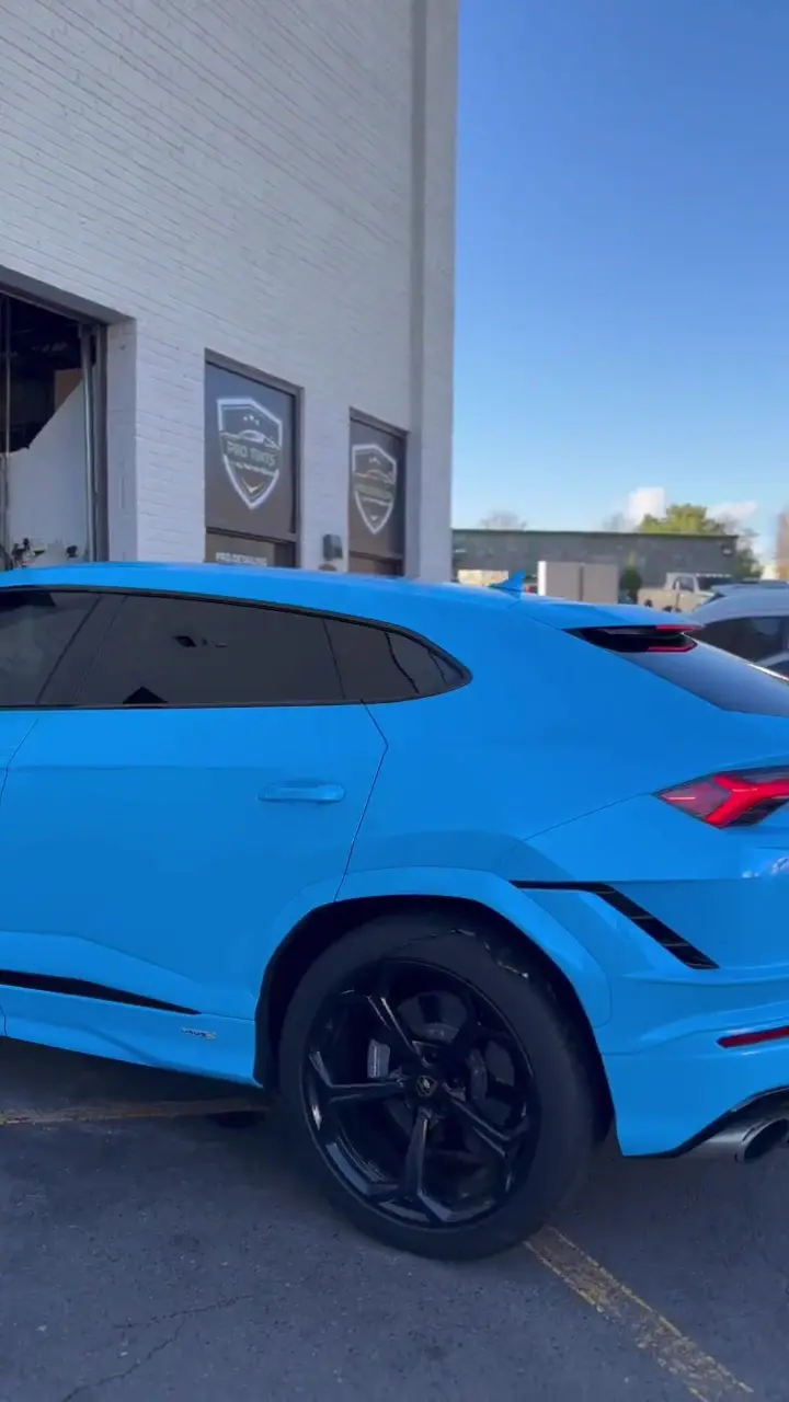 Light blue performance SUV with tinted windows, filmed in a slow walk-around.