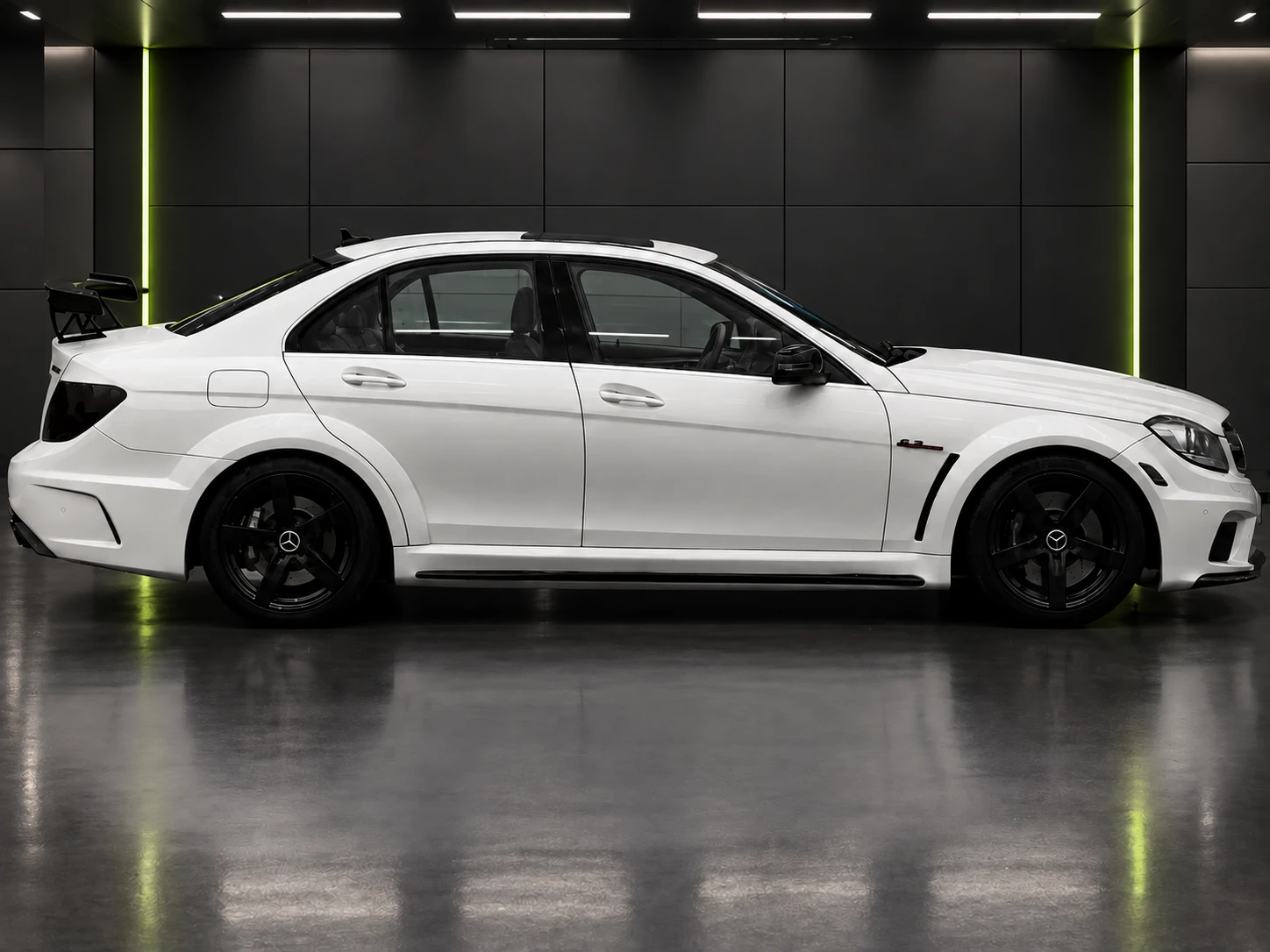 Photo-registered IRX 35 tint service visualization featuring the owner's white Mercedes-AMG C63 inside the PRO Tints showroom
