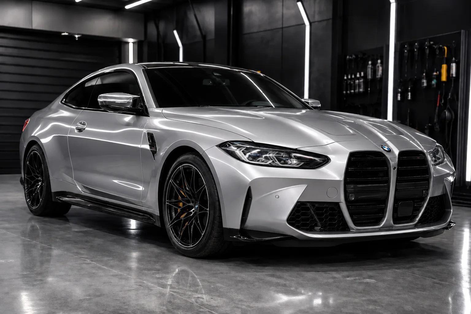Silver performance coupe in a dark studio with a clean, gloss-finished front end.