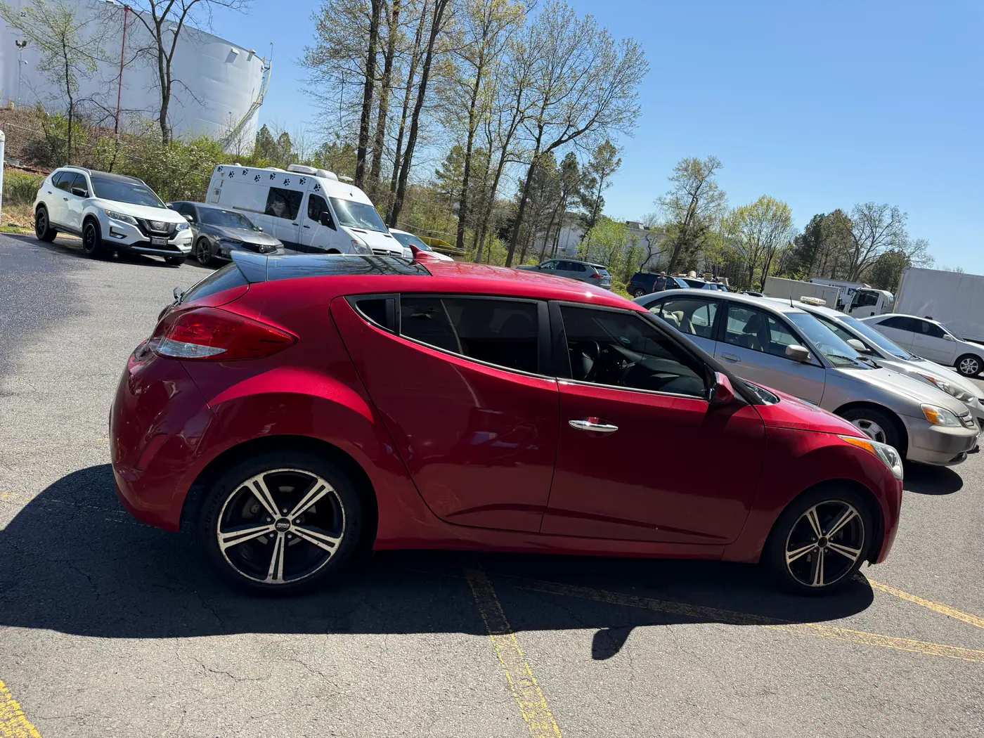 Red hatchback with tinted windows, photographed side-on: window tint by PRO Detailing, serving Bristow, VA drivers.