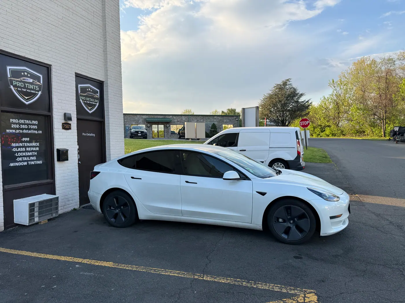 White sedan with tinted windows, photographed side-on: window tint by PRO Detailing, serving Chantilly, VA drivers.
